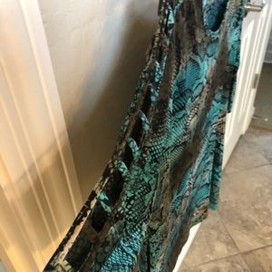 Blouse has look of snake skin and slits in sleeve